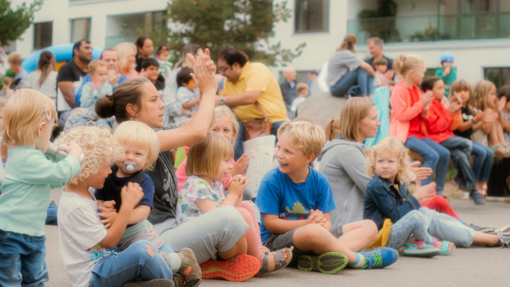 Fröhliche Kinder sitzen auf dem Boden Fröhliche Kinder sitzen auf dem Boden